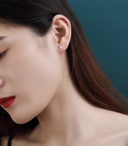 Detail of S925 sterling silver flower drop earrings with elegant long tassels on model
