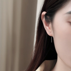 Detail of s925 sterling silver drop earrings with sphere stud and long minimalist tassel