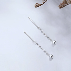 Detail of s925 sterling silver tassel earrings with delicate chain and small metal beads