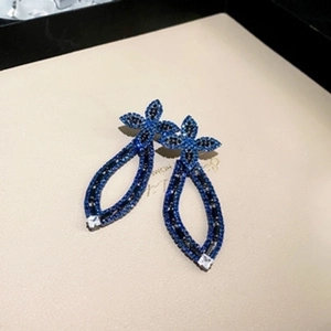 Detail of vintage navy blue and black crystal drop earrings with hollow bow-like structure