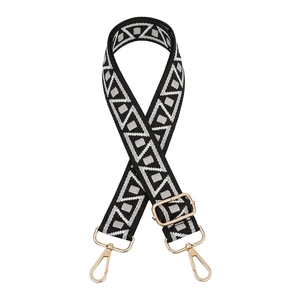 Detail of adjustable geometric woven strap with gold metal hooks and buckle