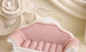 Mini pink velvet jewelry sofa display stand with gold embossed trim detail view