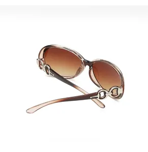 Detail of elegant brown gradient lenses with silver metal chain link on the temples