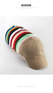 Stacked collection of washed cotton baseball caps in multiple vibrant colors and shades