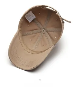 Detail of internal seams and 100% cotton wash label on khaki washed baseball cap