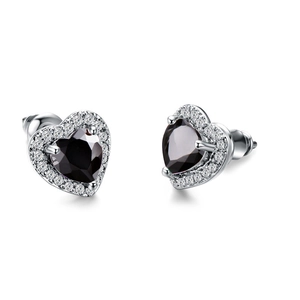Macro shot of silver stud earrings with heart-shaped black zircon and white halo crystals