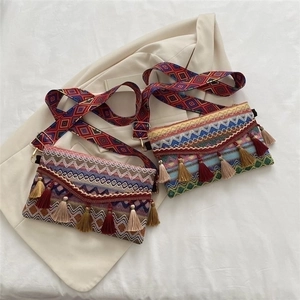 Ethnic woven crossbody bag with colorful tassels and bohemian style shoulder strap