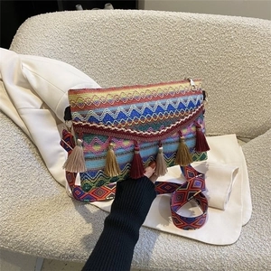 Detail of bohemian woven handbag featuring colorful geometric patterns and silk tassels