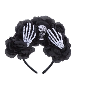 Halloween headband featuring black fabric roses and realistic skull with skeletal hands