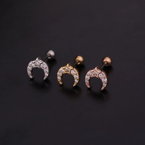 Detailed view of moon and star cartilage studs in silver, gold, and rose gold with zircons