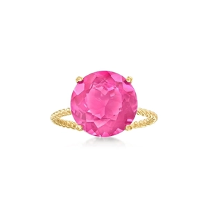 Macro view of four-prong gold ring featuring a large pink gemstone and twisted band