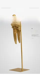 Artistic golden parrot sculpture on minimalist metal stand for home decor display