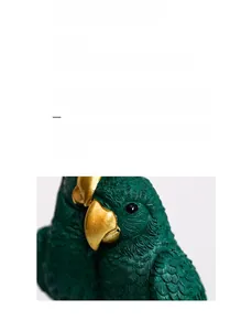 Close-up of resin parrot sculptures with detailed green feathers and gold beaks for home decor