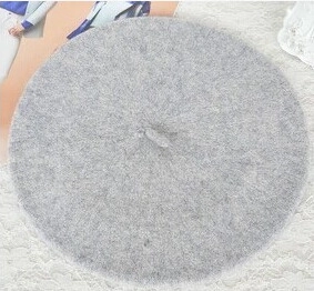 Detailed top view of a grey wool octagonal beret hat with soft felt texture fabric