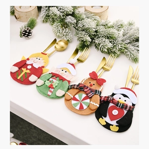Detail of Christmas cutlery holders with gingerbread man and angel holiday table decor