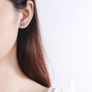 Classic S925 sterling silver six-prong moissanite stud earring worn by a model