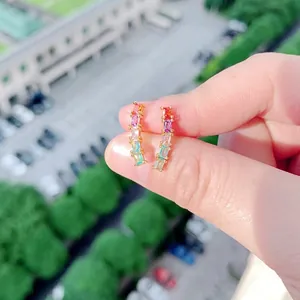 Rainbow gradient hoop earrings featuring rectangular multi-color stones in gold setting