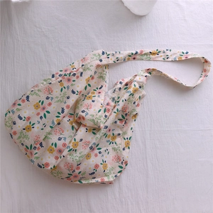 Close-up detail of soft floral cotton tote bag with vintage pastoral print pattern