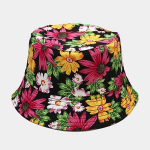 Women's reversible sun hat with large pink and yellow daisy floral prints on black canvas