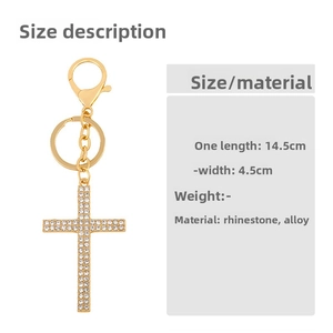 Detail of golden cross keychain with white rhinestones and sizing specifications