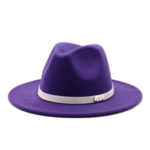 Detail of dark purple felt fedora with a grey leather band and engraved metal buckle