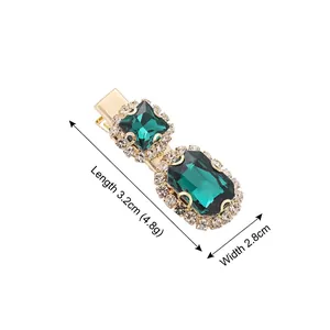 Elegant gold duckbill hair clip featuring emerald green crystals and white rhinestones