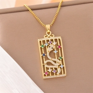 Snake pendant necklace with diamonds and colorful gems in a golden rectangle frame