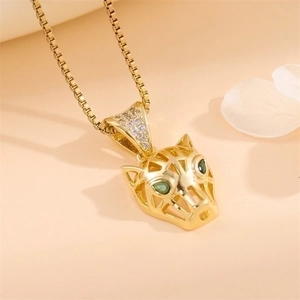 Minimalist gold leopard head necklace with green gemstone eyes and sparkling zircon pendant