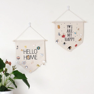 Detail of canvas wall banners with wood poles and hanging ropes for pin badge collection