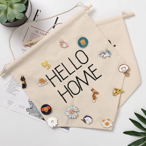 Detail view of beige canvas banner for enamel pin storage with Hello Home print