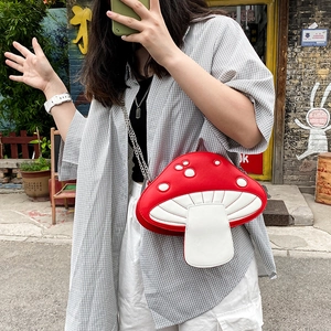Quirky mushroom-shaped crossbody bag in red and white polka dot with silver chain strap
