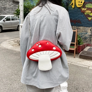 Fashionable red and white mushroom shaped PU crossbody bag with chain strap shown on model