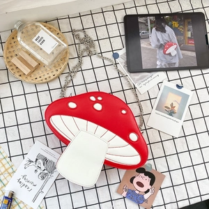 Top view of a cute red and white mushroom shaped PU leather crossbody bag with chain