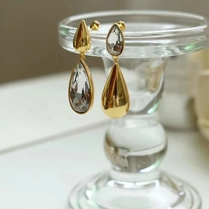 Asymmetric gold teardrop earrings with sparkling clear crystals in a long vintage style