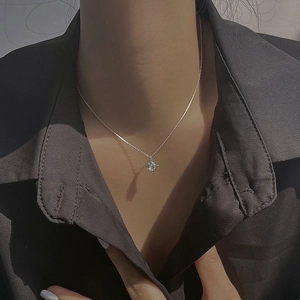 925 silver star necklace with light blue topaz pendant on model in retro style