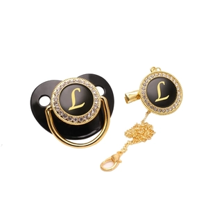 Luxury black and gold baby pacifier with rhinestone crown and letter L initial clip