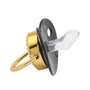 Golden and black baby pacifier with silicone nipple shown in a professional side view
