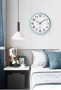 Modern light blue silent wall clock in a cozy bedroom setting with quartz movement