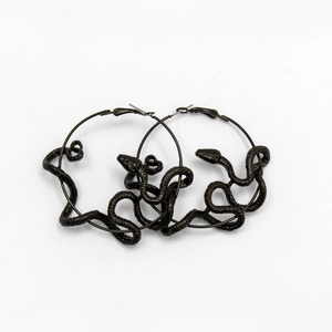 Detail of black snake-wrapped hoop earrings with intricate scale texture on white background