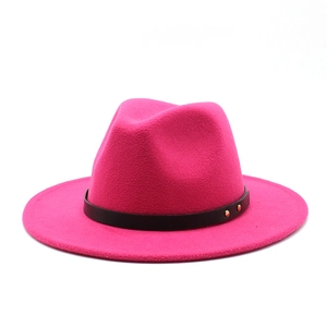 Macro detail of rose red wool fedora with black leather band and gold metal rivets