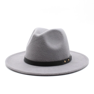Detail of grey wool fedora hat featuring black leather band and golden metal rivets
