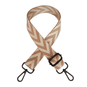 Detail of adjustable beige and brown wave patterned canvas strap with gunmetal hardware