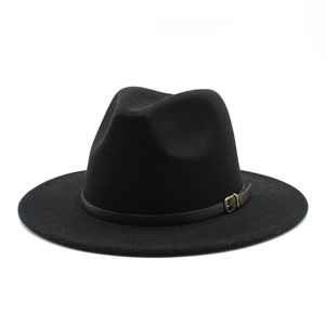 Detail of black wool fedora with dark brown leather strap and gold buckle accent
