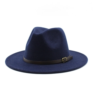 Detail of dark blue wool fedora with brown leather band and gold metal buckle close-up