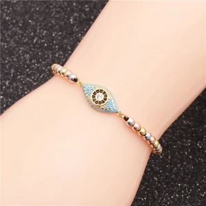 Detail of beaded evil eye bracelet with colorful metal beads and zircon inlay