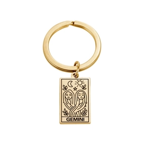 Golden stainless steel Gemini zodiac keychain with rectangular engraved pendant on white background