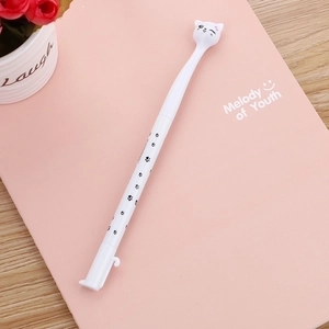 Creative white cat-shaped gel pen with paw prints resting on a pink notebook