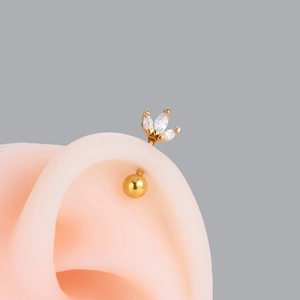 Gold helix cartilage piercing with three marquise-cut white zircons in fan shape
