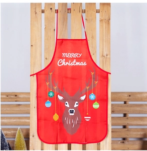 Detail of red polyester Christmas apron with reindeer print and Merry Christmas text