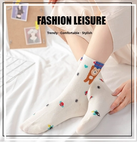 Close-up of mid-tube socks featuring cute bear, planet, and star prints on cotton fabric
